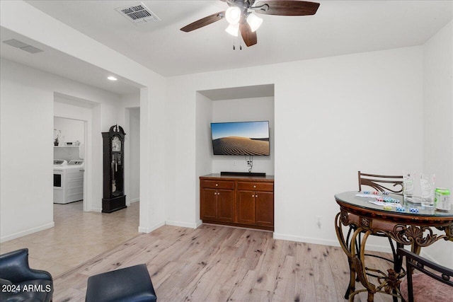 tiled living room featuring ceiling fan and independent washer and dryer