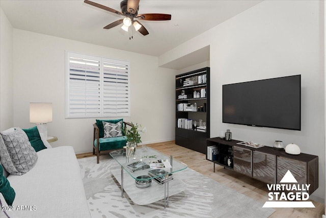 living room with light hardwood / wood-style flooring and ceiling fan