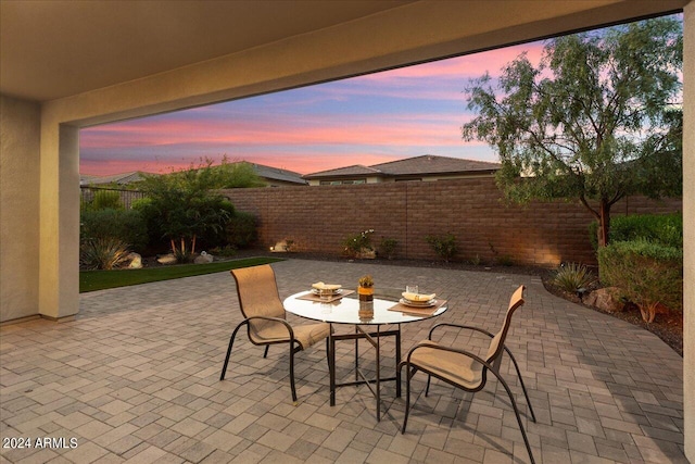 view of patio terrace at dusk