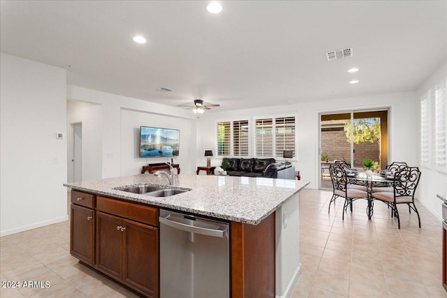 kitchen with a wealth of natural light, sink, stainless steel dishwasher, ceiling fan, and an island with sink