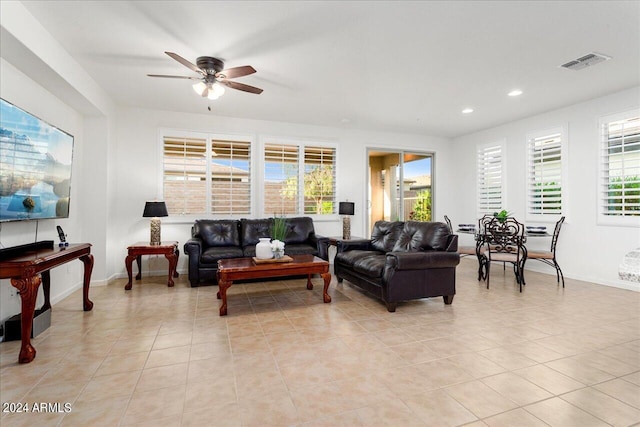 tiled living room with ceiling fan