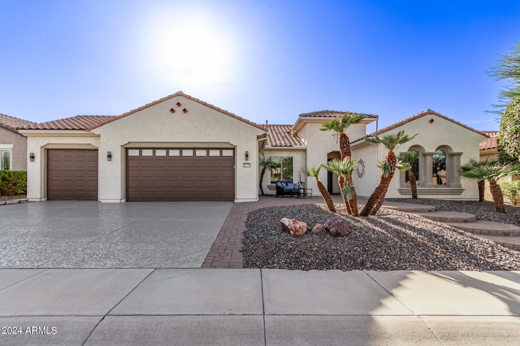 mediterranean / spanish-style home with a garage