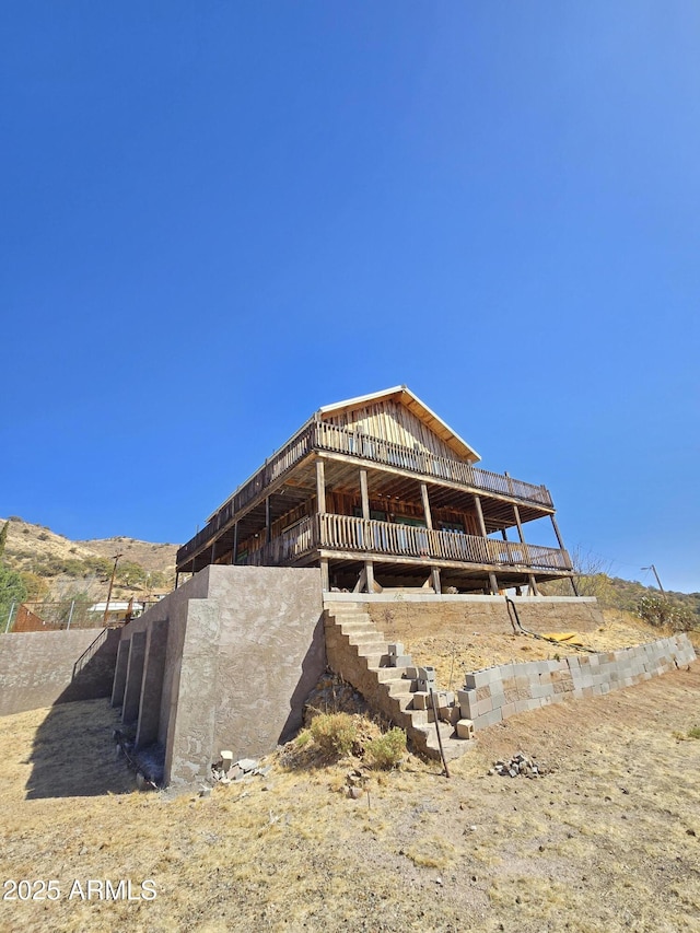 rear view of house featuring a mountain view