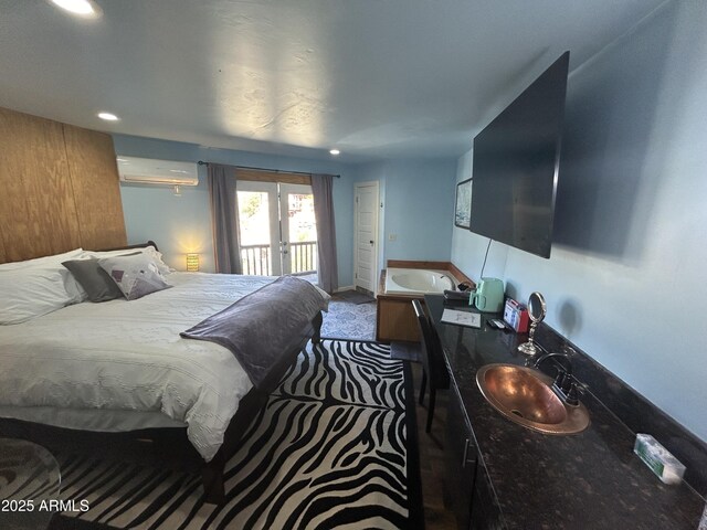 carpeted bedroom with recessed lighting, a sink, access to outside, french doors, and a wall mounted AC