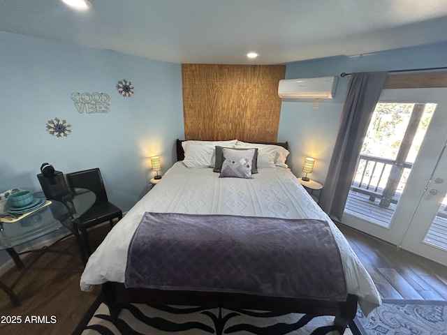 bedroom with a wall mounted air conditioner, wood finished floors, and recessed lighting