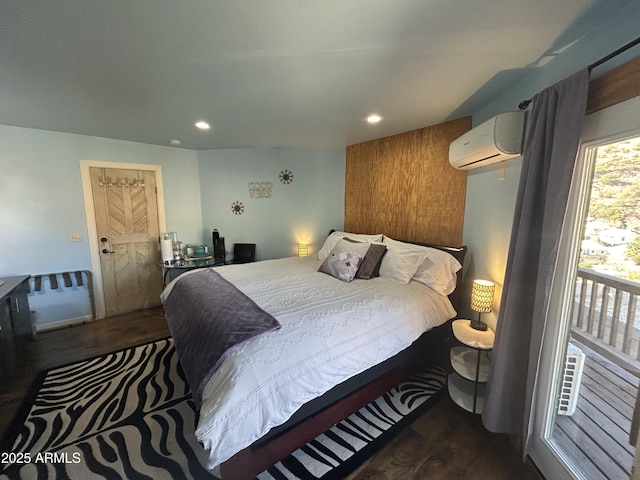 bedroom featuring recessed lighting, wood finished floors, and a wall mounted air conditioner