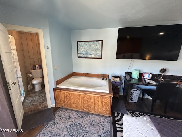 full bathroom featuring a whirlpool tub and toilet