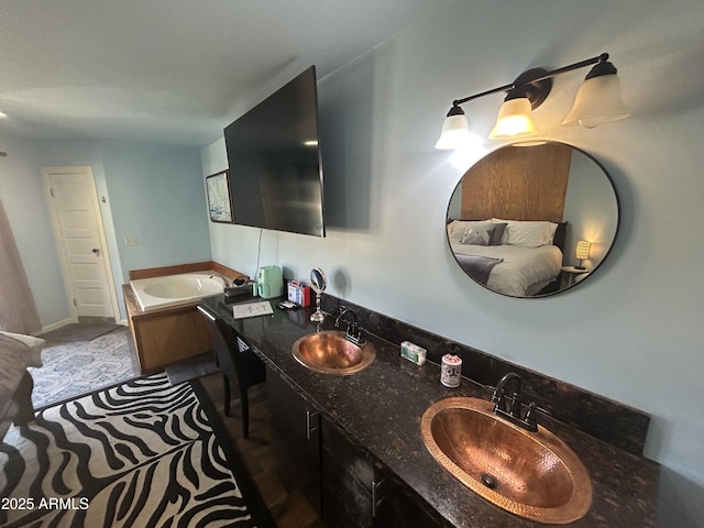 full bath with double vanity, a garden tub, and a sink