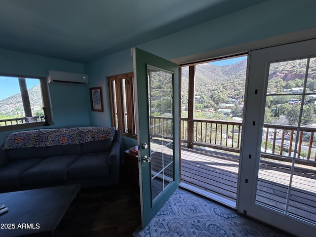 living area featuring an AC wall unit, a mountain view, and french doors