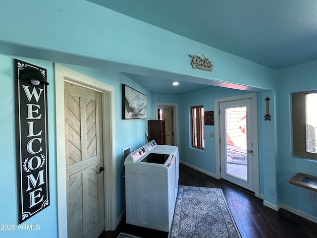 laundry room featuring laundry area, washing machine and dryer, dark wood finished floors, and baseboards