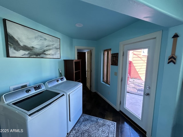 laundry room featuring washing machine and dryer, laundry area, and baseboards