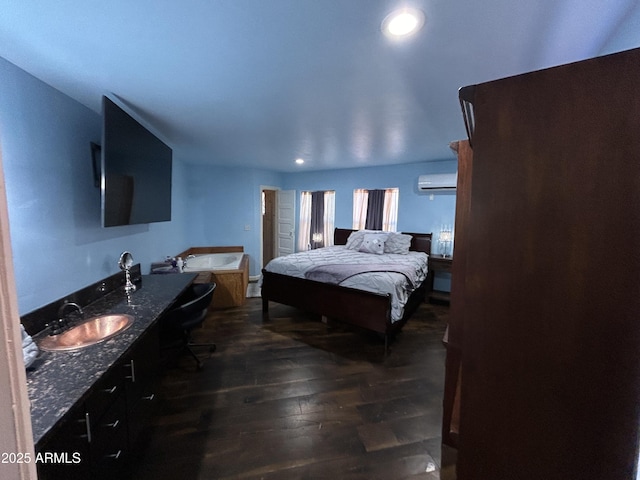 bedroom featuring recessed lighting, dark wood finished floors, a sink, and a wall mounted air conditioner