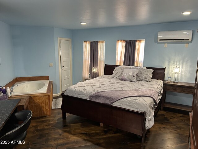 bedroom with a wall unit AC, wood finished floors, and recessed lighting