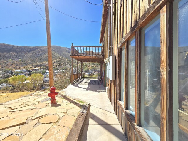 view of patio featuring a balcony and a mountain view