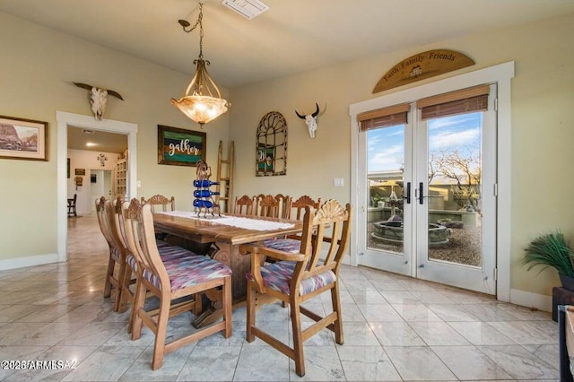 dining space with marble finish floor, baseboards, french doors, and visible vents