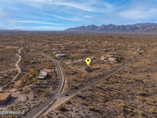 drone / aerial view featuring a mountain view and a desert view