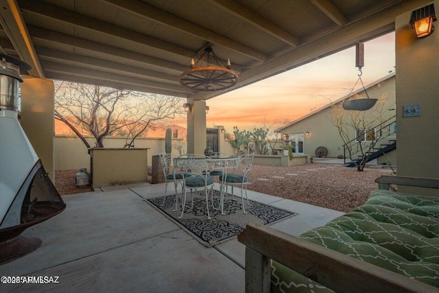 view of patio / terrace featuring stairway, fence, and outdoor dining space