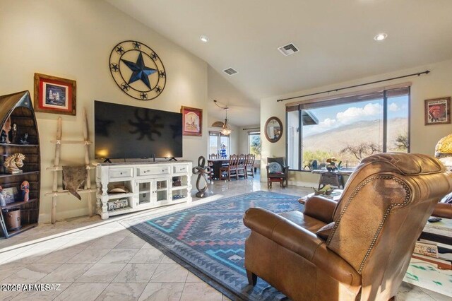 living room with high vaulted ceiling, marble finish floor, visible vents, and recessed lighting