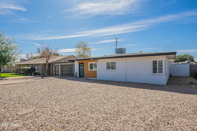 ranch-style house with cooling unit and fence