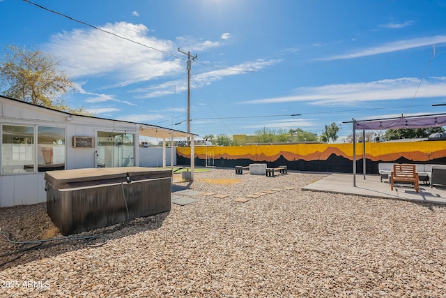 view of yard featuring fence, a hot tub, and a patio