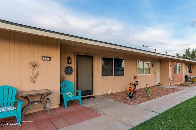 view of exterior entry featuring a patio area