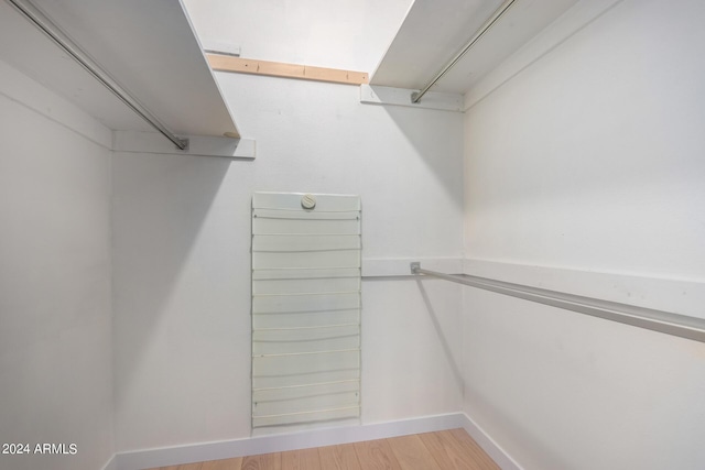 walk in closet with hardwood / wood-style floors