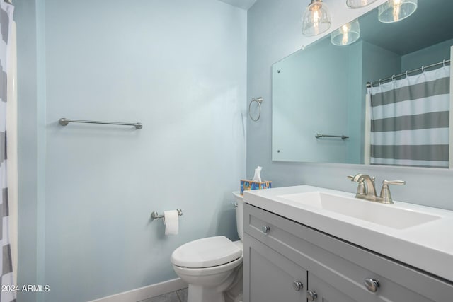 bathroom with curtained shower, toilet, tile patterned flooring, and vanity