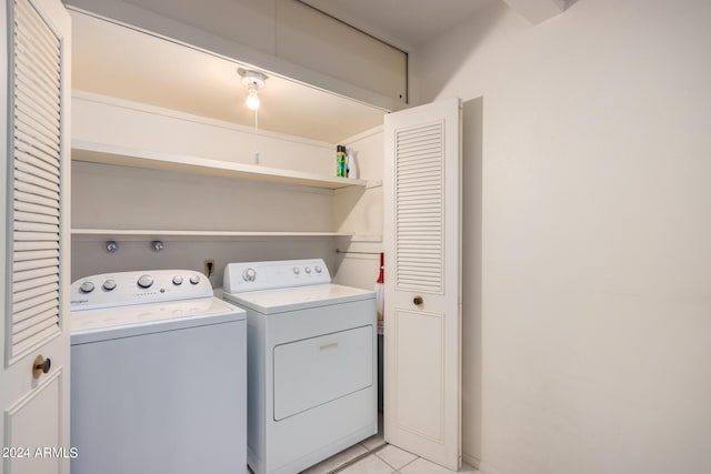 laundry room featuring independent washer and dryer and light tile patterned flooring