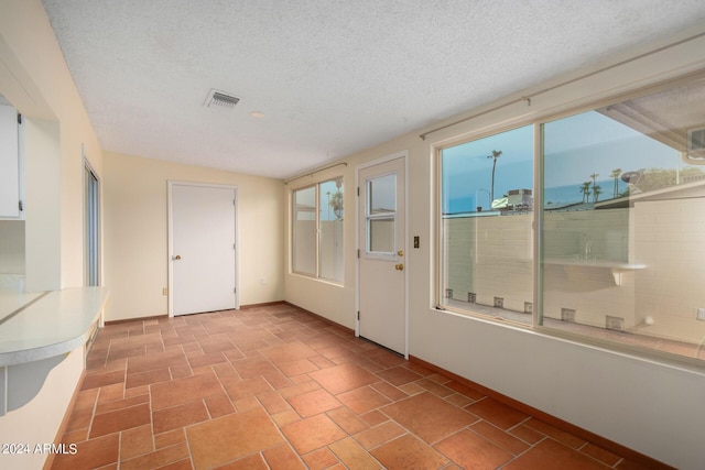 entryway with a textured ceiling