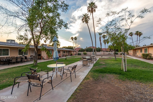 view of property's community with a patio area and a yard