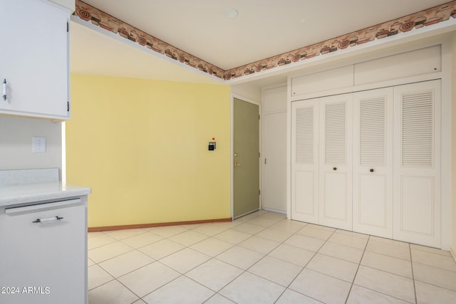 interior space featuring white cabinetry and light tile patterned flooring