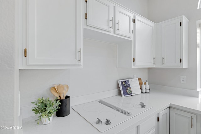 kitchen with white cabinets and white electric stovetop