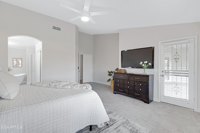 carpeted bedroom featuring ceiling fan, lofted ceiling, and ensuite bath