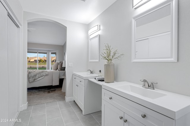 bathroom featuring tile patterned floors, vanity, and lofted ceiling