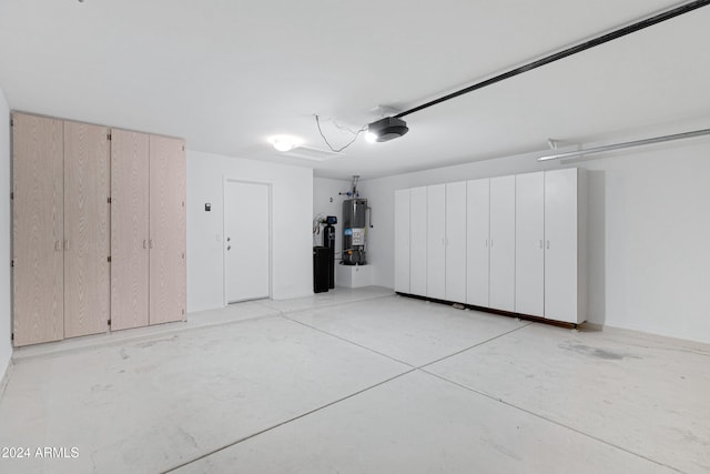 garage with a garage door opener and water heater