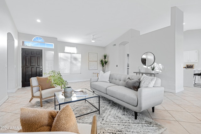 living room featuring light tile patterned floors, vaulted ceiling, and ceiling fan