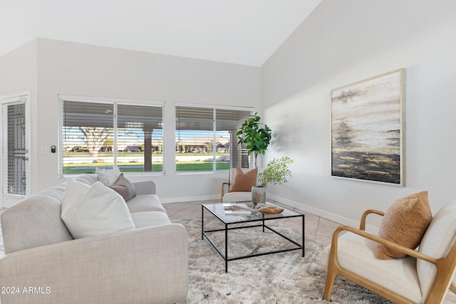 living room with lofted ceiling, a healthy amount of sunlight, and light tile patterned flooring