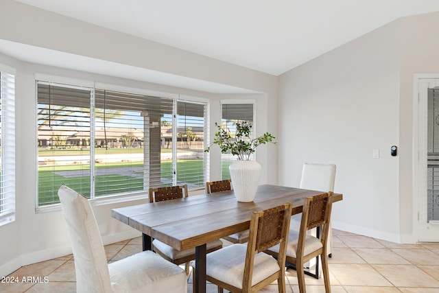 tiled dining area with lofted ceiling