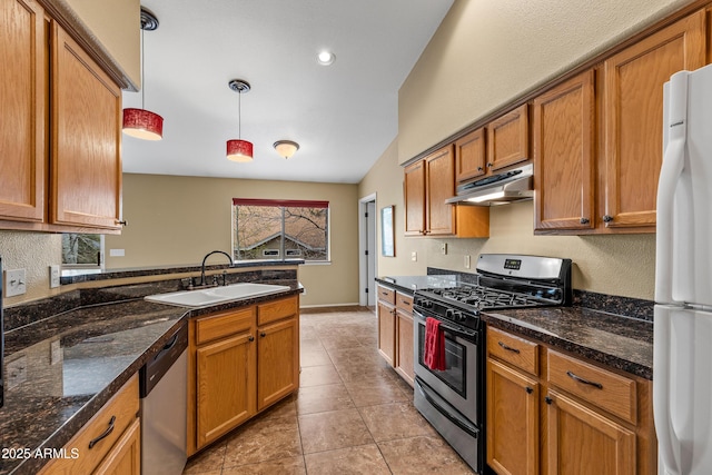 69 E Mohawk Dr, Flagstaff, AZ 86005 - kitchen featuring appliances with stainless steel finishes, under cabinet range hood, a sink, brown cabinets, and hanging light fixtures