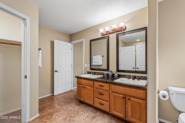 69 E Mohawk Dr, Flagstaff, AZ 86005 - full bath with toilet, double vanity, and baseboards