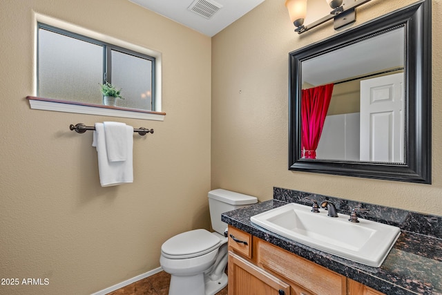 69 E Mohawk Dr, Flagstaff, AZ 86005 - bathroom featuring toilet, vanity, and baseboards
