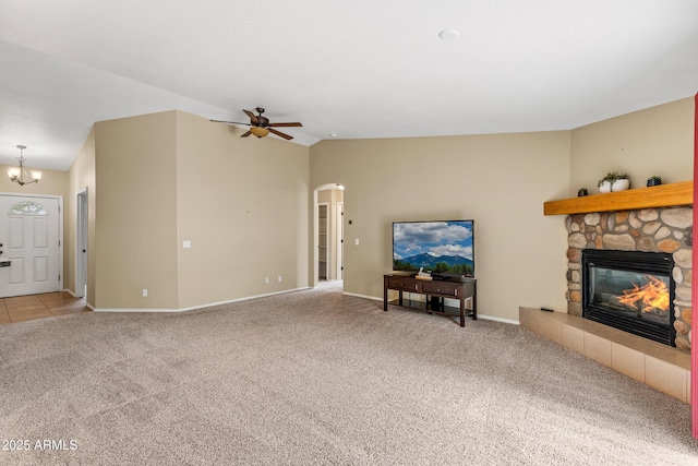 69 E Mohawk Dr, Flagstaff, AZ 86005 - living room featuring carpet, arched walkways, a stone fireplace, ceiling fan, and baseboards