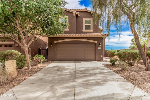 20261 W Desert Bloom St, Buckeye, AZ 85326 - view of front facade with a tiled roof, driveway, and stucco siding