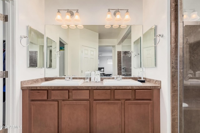 20261 W Desert Bloom St, Buckeye, AZ 85326 - bathroom with double vanity, a tile shower, a sink, and ensuite bathroom
