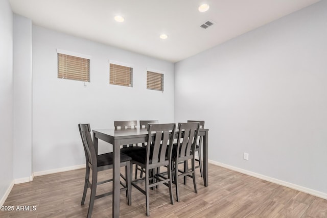 20261 W Desert Bloom St, Buckeye, AZ 85326 - dining area with baseboards, recessed lighting, wood finished floors, and visible vents