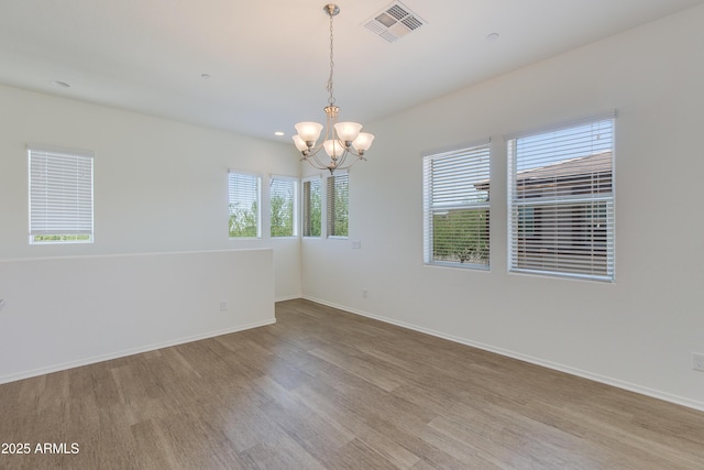 14870 W Encanto Blvd Unit 2006, Goodyear, AZ 85395 - spare room featuring healthy amount of natural light, light wood-style flooring, a chandelier, and recessed lighting