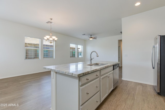 14870 W Encanto Blvd Unit 2006, Goodyear, AZ 85395 - kitchen featuring appliances with stainless steel finishes, light wood-style flooring, ceiling fan, decorative light fixtures, and a chandelier