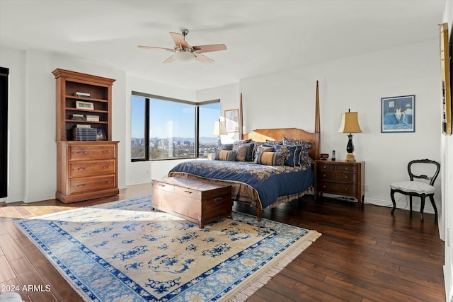 bedroom with dark hardwood / wood-style floors and ceiling fan