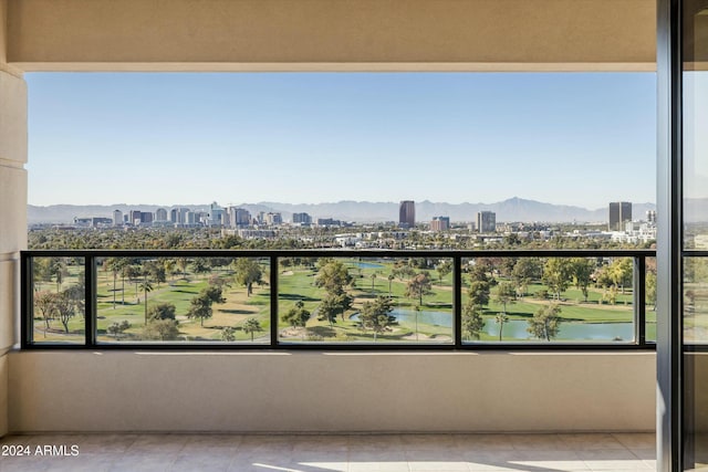 balcony featuring a water and mountain view