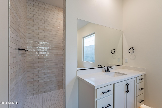 full bath featuring vanity and a tile shower